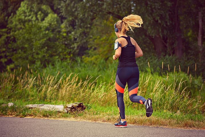 Solo female runner jogging through phoenix park