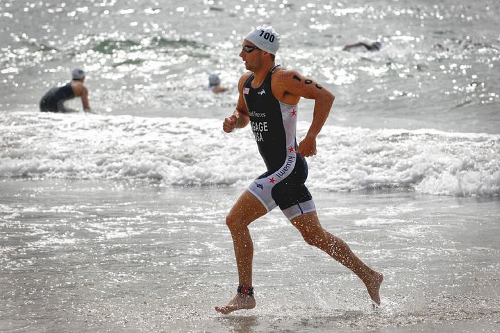 Sole male runner jogging on beach