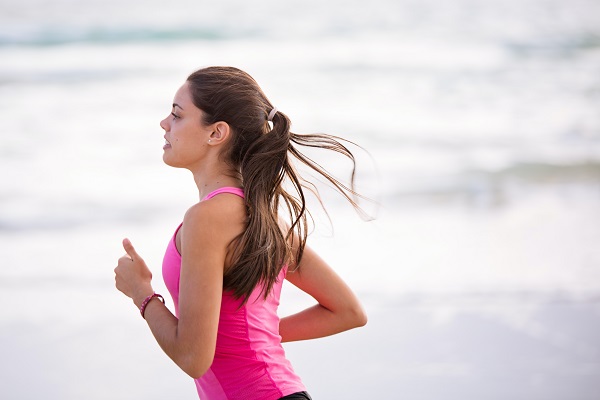 Soloe female runner joggin on beach